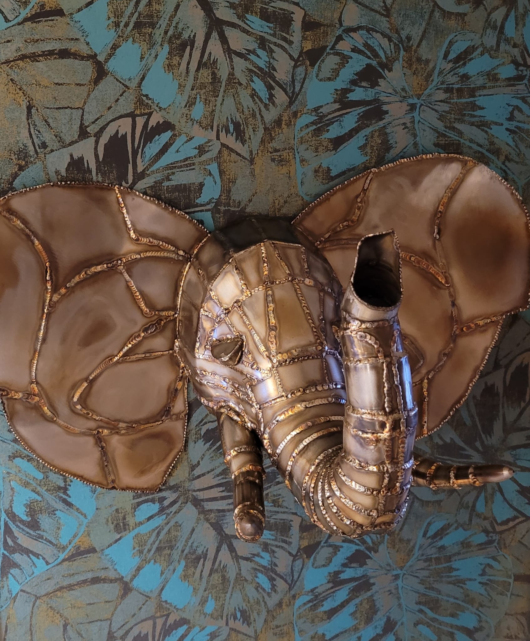 Brass elephant mounted on decorative wall